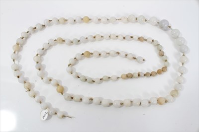 Lot 515 - Old Chinese jade/hardstone necklace with a long string of graduated beads measuring approximately 15mm to 9mm. Length approximately 118cm.