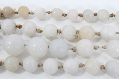 Lot 515 - Old Chinese jade/hardstone necklace with a long string of graduated beads measuring approximately 15mm to 9mm. Length approximately 118cm.