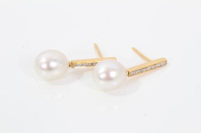 Lot 521 - Pair of cultured pearl and diamond pendant earrings, each with a pear shape cultured pearl measuring approximately 11.3 x 9.8mm, suspended from a diamond set gold bar with pierced fittings, length...