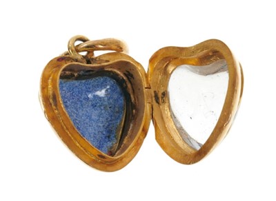 Lot 525 - Victorian gold and red enamel heart shaped locket enclosed by glazed front with intaglio engraved gothic 'A', the reverse with red guilloche enamel and suspended from a snake loop. 25mm x 15mm.