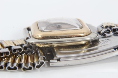 Lot 554 - 1920s gold and stainless steel wristwatch with square silvered dial, black enamel Arabic numerals and blued steel hands, gold bezel and gold winding crown in stainless steel case with 18ct gold bac...