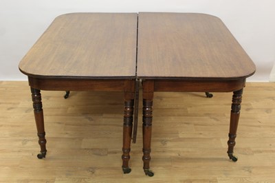 Lot 1388 - Regency mahogany extending dining table, rounded rectangular form with drop leaf on turned legs and brass castors