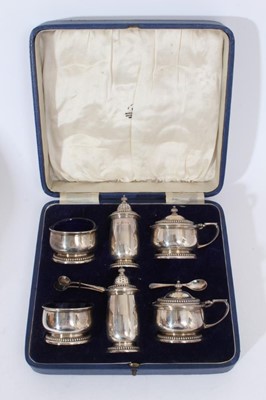 Lot 376 - George VI silver six piece cruet set comprising two salt cellars with blue glass liners, two pepperettes and two mustard pots with blue glass liners (Birmingham 1937), together with three silver sa...