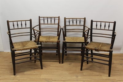 Lot 1405 - Set of four 19th century stick back country elbow chairs, each with bobbin turned top rail and rush seat on turned understructure