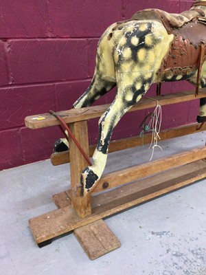 Lot 1358 - Antique painted wooden rocking horse and a vintage child's perambulator