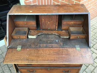 Lot 157 - George III oak bureau with three secret drawers concealed below the bottom drawer