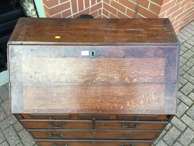 Lot 157 - George III oak bureau with three secret drawers concealed below the bottom drawer
