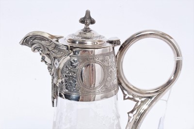 Lot 395 - Victorian glass claret jug of tapered form, with etched decoration of a cross amongst Holly and birds, silver plated mount with engraved scroll decoration, Bacchus mask and domed hinged cover, 29cm...