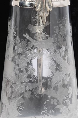 Lot 395 - Victorian glass claret jug of tapered form, with etched decoration of a cross amongst Holly and birds, silver plated mount with engraved scroll decoration, Bacchus mask and domed hinged cover, 29cm...