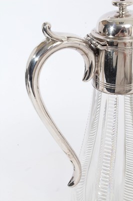 Lot 396 - Victorian cut glass claret jug of baluster form, silver plated mount with reeded decoration and hinged cover, with scroll handle, 29.5cm overall height