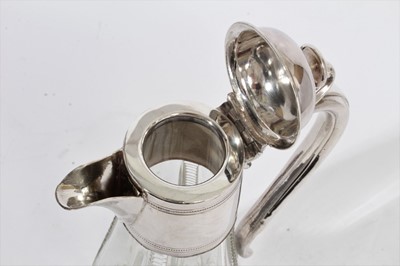 Lot 396 - Victorian cut glass claret jug of baluster form, silver plated mount with reeded decoration and hinged cover, with scroll handle, 29.5cm overall height