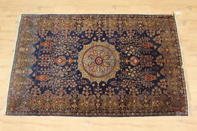 Lot 1351 - Part silk Kashan rug, with central medallion and floral vases on midnight blue ground main meander border, 210 x 126cm