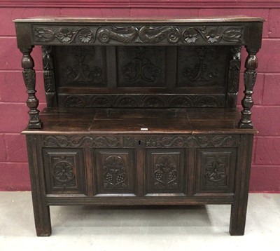 Lot 1378 - Antique carved oak court cupboard with 17th century elements, carved frieze and panelled back, the base cupboard below enclosed by hinged top, the front bearing carved initials 'MW' and dated '1689...