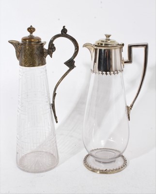 Lot 397 - Victorian cut glass claret jug of tapered form, with etched Greek key decoration and star cut base, silver plated mount with engraved decoration, 30.5cm overall height, together with another simila...