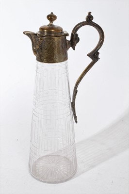 Lot 397 - Victorian cut glass claret jug of tapered form, with etched Greek key decoration and star cut base, silver plated mount with engraved decoration, 30.5cm overall height, together with another simila...