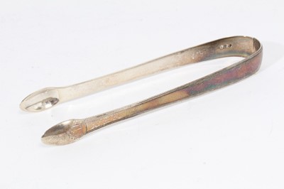 Lot 403 - Pair of George III silver sugar tongs with brightcut engraved decoration, (London 1794), maker Peter & Ann Bateman, together with three other pairs of Georgian silver sugar tongs (various dates and...