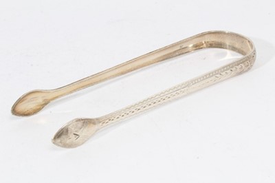 Lot 403 - Pair of George III silver sugar tongs with brightcut engraved decoration, (London 1794), maker Peter & Ann Bateman, together with three other pairs of Georgian silver sugar tongs (various dates and...