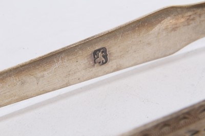 Lot 404 - Pair of George III silver sugar tongs with britecut engraved decoration, (London 1793), maker Peter & Ann Bateman, together with four other pairs of Georgian silver sugar tongs (various dates and m...