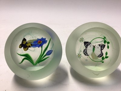 Lot 1038 - Two Caithness glass paperweights with butterfly ornament