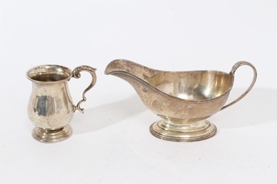 Lot 422 - Edwardian silver christening mug of baluster form with scroll handle, on circular foot, (Birmingham 1909), maker William Aitkin, together with a George V silver sauce boat of conventional form, on...