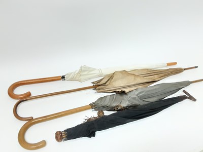 Lot 984 - Three vintage shooting sticks, together with four parasols (7)