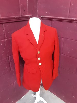 Lot 986 - 1960s red hunting coat and 1930s red evening tail coat, both with East Essex brass buttons