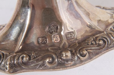 Lot 435 - Victorian silver bonbon dish of navette form with embossed decoration (Birmingham 1895), together with two graduated Victorian silver Quaiches with pierced decoration (London 1893), maker William C...