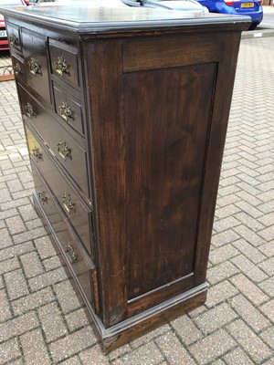 Lot 212 - Edwardian oak chest with central hat drawer flanked by four short drawers and three long graduated drawers below, 122cm wide, 53cm deep, 121cm high