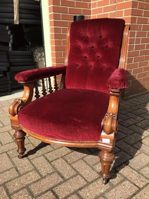 Lot 221 - Late Victorian mahogany framed armchair with buttoned red upholstery on turned front legs and castors