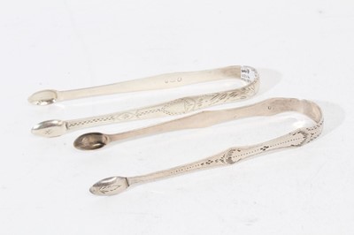 Lot 504 - Pair of George III Newcastle silver sugar tongs, with bright cut engraved decoration