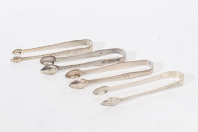 Lot 301 - 4 pairs of George III Exeter silver sugar tongs, with bright cut engraved decoration