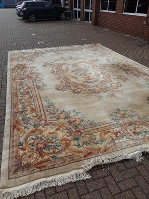 Lot 238 - Large Chinese carpet with floral decoration on beige ground, 558cm x 364cm
