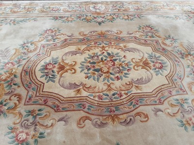 Lot 238 - Large Chinese carpet with floral decoration on beige ground, 558cm x 364cm