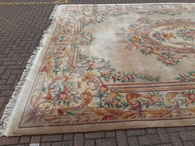 Lot 238 - Large Chinese carpet with floral decoration on beige ground, 558cm x 364cm