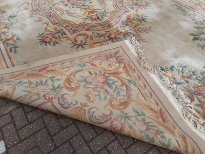 Lot 238 - Large Chinese carpet with floral decoration on beige ground, 558cm x 364cm