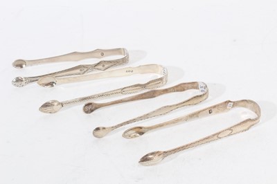 Lot 509 - 4 pairs of George III silver sugar tongs, with bright cut engraved decoration