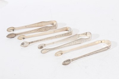 Lot 510 - 4 pairs of George III silver sugar tongs, with bright cut engraved decoration