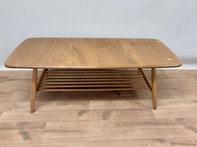 Lot 240 - Ercol elm coffee table with magazine rack undertier, 104cm wide, 46cm deep, 36cm high