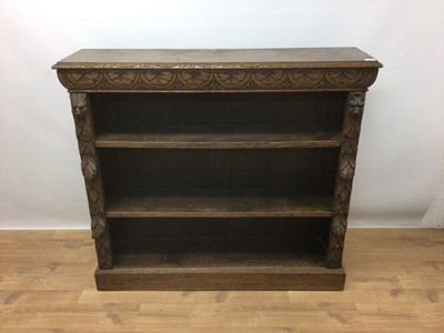 Lot 266 - Late Victorian carved oak bookcase with adjustable shelves, bearing label J. Matthews & Sons, 8 & 9 Jewry Street, Winchester, 122cm wide, 31cm deep, 110cm high