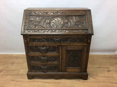 Lot 267 - Late Victorian carved oak bureau with fitted interior, four drawers and cupboard below with carved lion mask handles, 91cm wide, 46cm deep, 101cm high