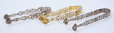 Lot 307 - Pair of George III silver gilt sugar tongs with pierced and engraved decoration, London circa. 1760, maker Thomas Wallis I 12.5cm overall, together with another two pairs of similar Georgian silver...