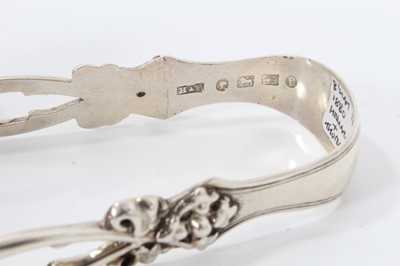 Lot 308 - Pair of Edwardian silver sugar tongs with pierced and engraved decoration, (Sheffield 1907), 11cm overall, together with another four pairs of similar silver sugar tongs, (various dates and makers)...