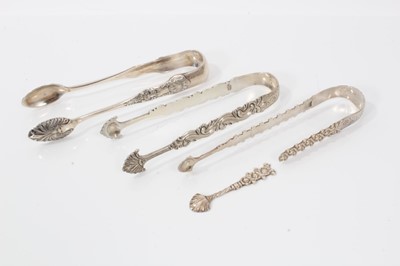 Lot 310 - Pair of George III silver sugar tongs with cast and engraved decoration, London circa. 1770, 13.5cm overall, together with another two pairs of silver sugar tongs, (various dates and makers) (3)