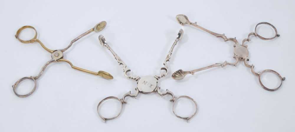 Lot 311 - Pair of George II silver gilt scissor action sugar nips, circa. 1730, 11cm overall, together with another two pairs of Georgian silver scissor action sugar nips, (various dates and makers) (3)