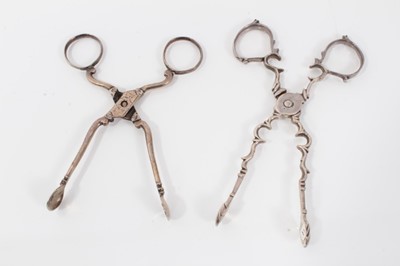 Lot 312 - Pair of George III silver scissor action sugar nips, circa. 1760, 11cm overall, together with another pair of Georgian silver scissor action sugar nips, (marks rubbed) (2)