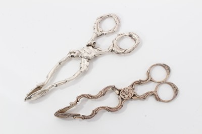 Lot 313 - Pair of George III silver scissor action sugar nips, circa. 1760, 12cm overall, together with a pair of good quality William IV silver scissor action sugar nips, (London 1834) (2)