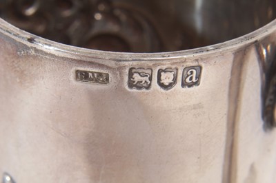 Lot 341 - Victorian silver christening mug of cylindrical form with embossed scroll decoration and one other