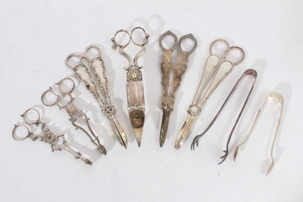 Lot 478 - Two pairs Georgian sugar nips, together with sugar tongs and plated grape scissors