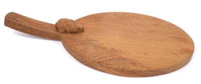 Lot 879 - Peter 'Rabbitman' Heap of Wetwang, oak cheese board of oval form with carved Rabbit signature to the base of the handle.  
N.B. Peter Heap was a former ‘Mouseman’ apprentice, before leaving to set...