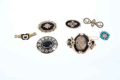 Lot 553 - Seven Regency and Victorian mourning brooches to include a Regency gold enamel and emerald ring converted to a brooch, dated 1831, Victorian banded agate and enamel oval mourning brooch, and five o...